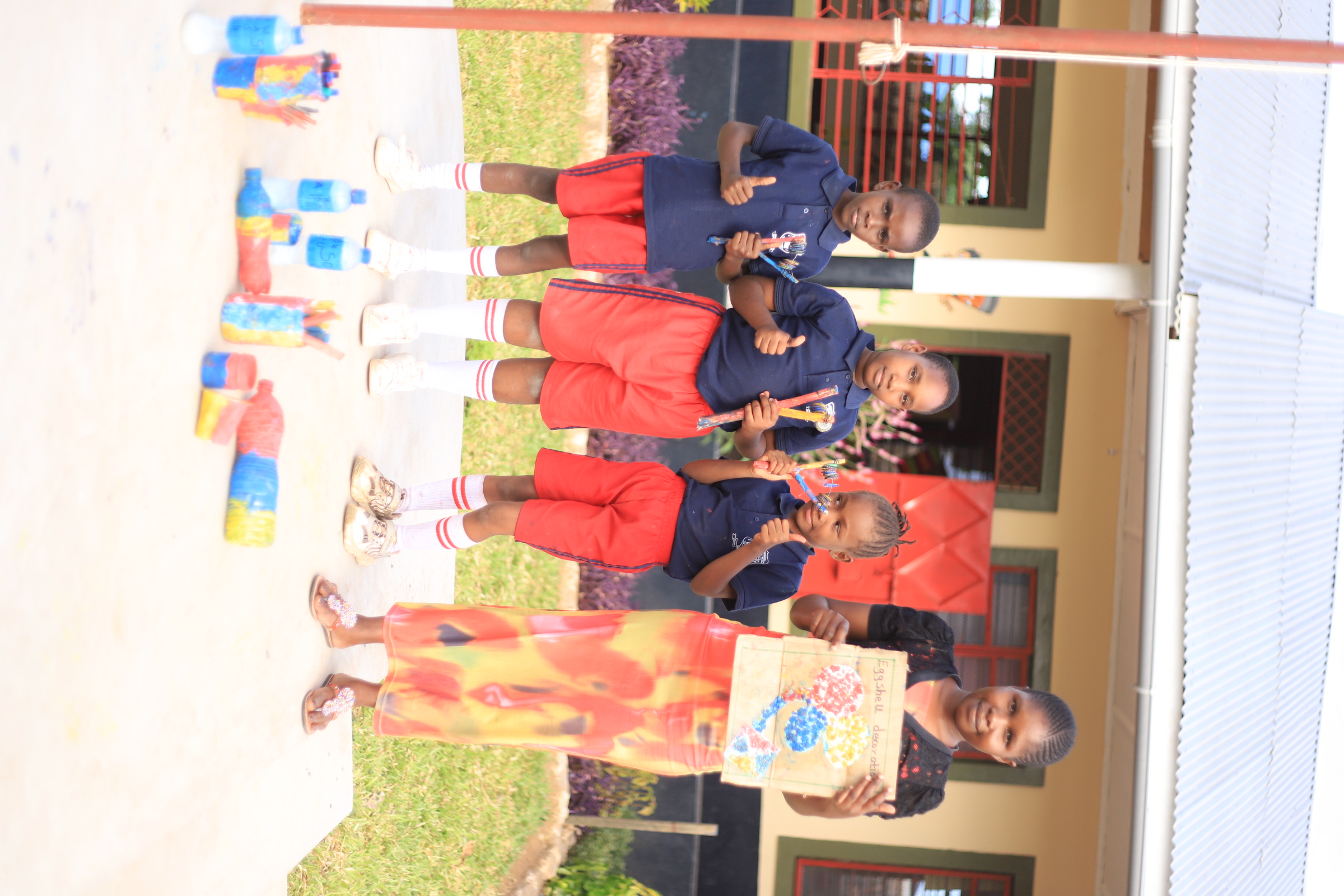 Children painting a large canvas outdoors